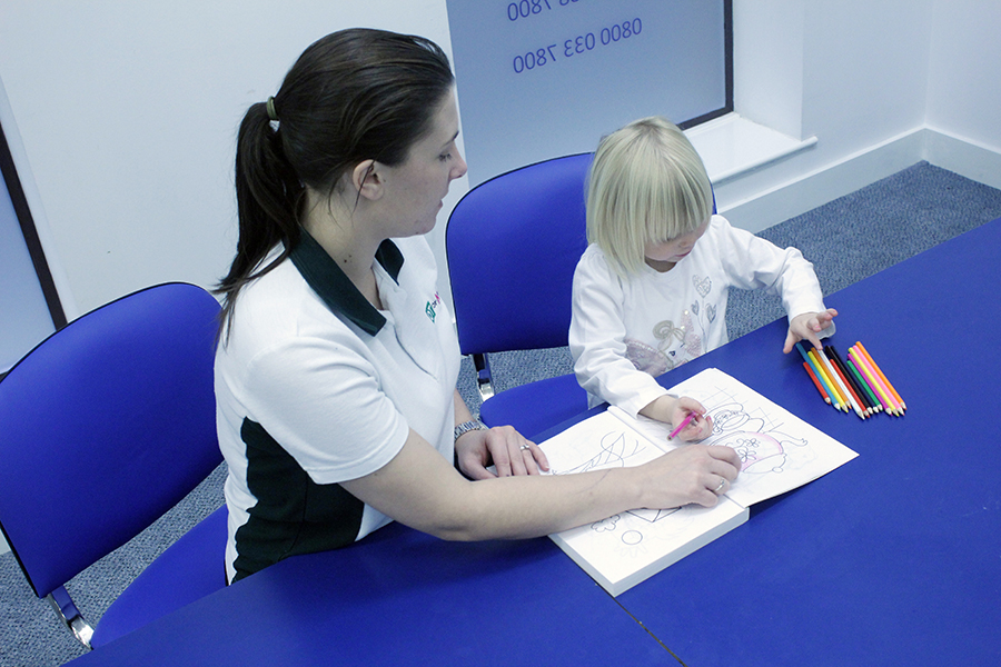 Therapist and child colouring